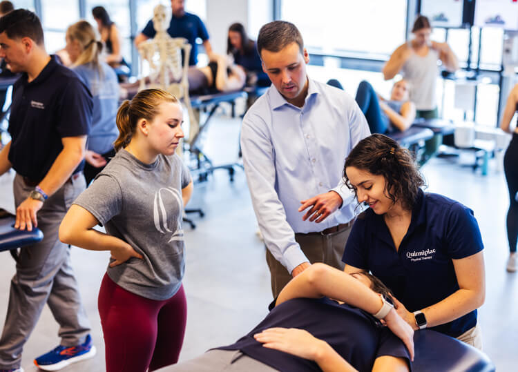 Physical therapy students work with patients and faculty