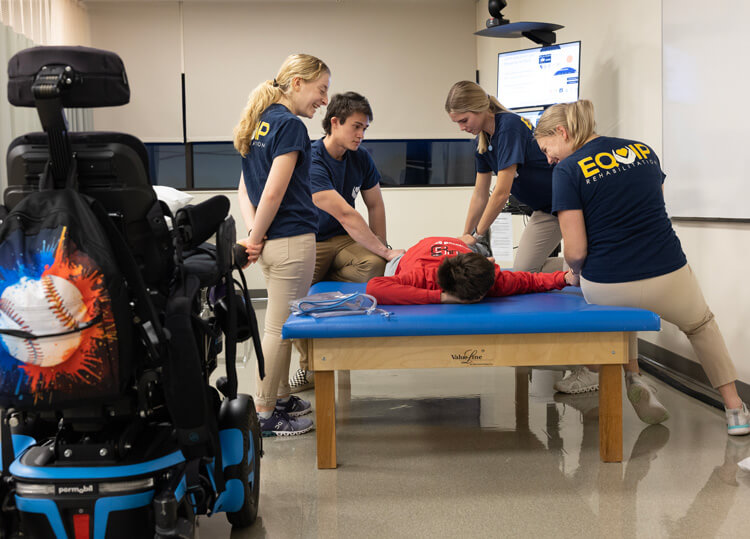 Physical therapy students work with patients and faculty